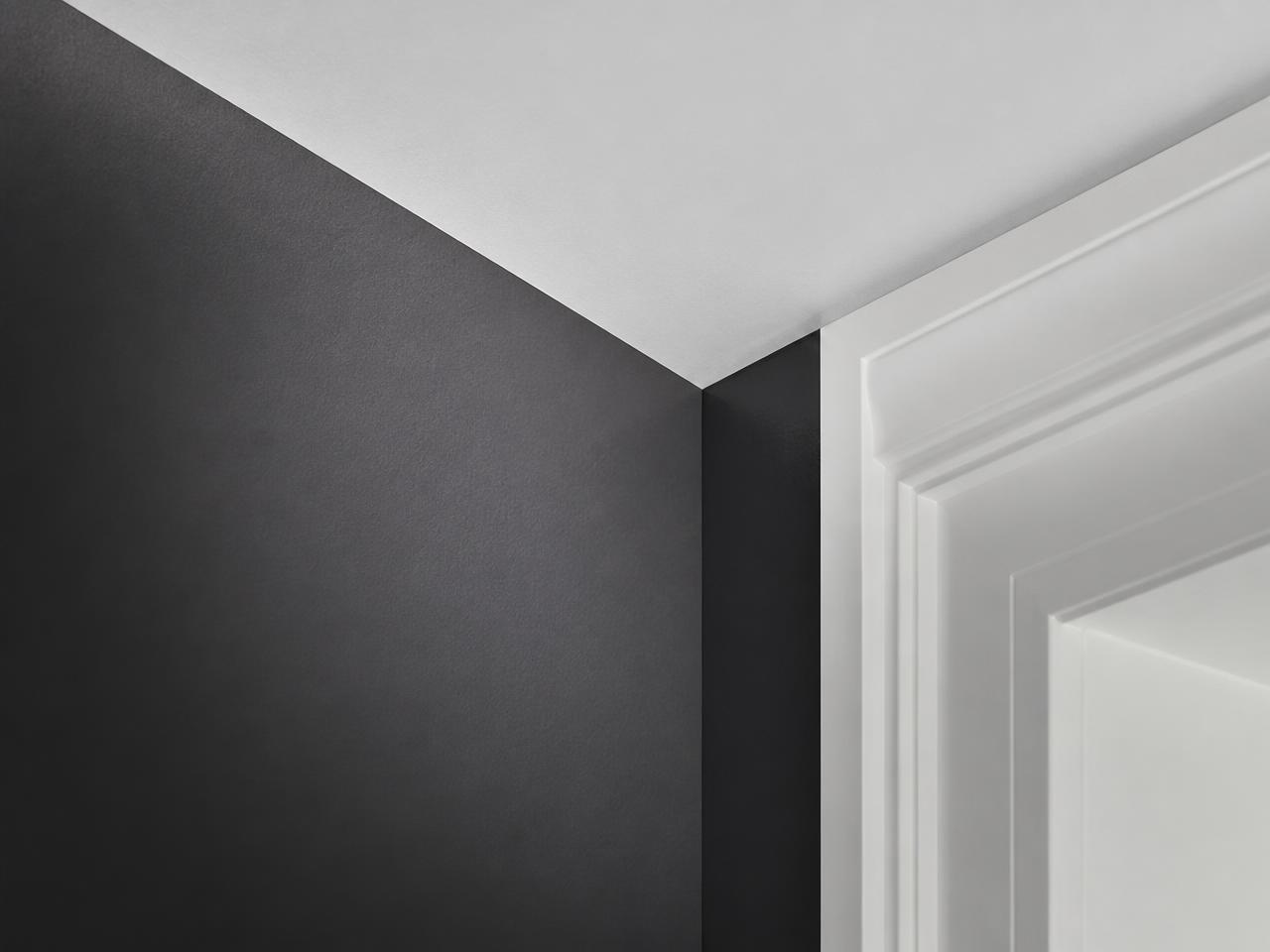 Crisp cut-in line where a charcoal wall meets white ceiling trim